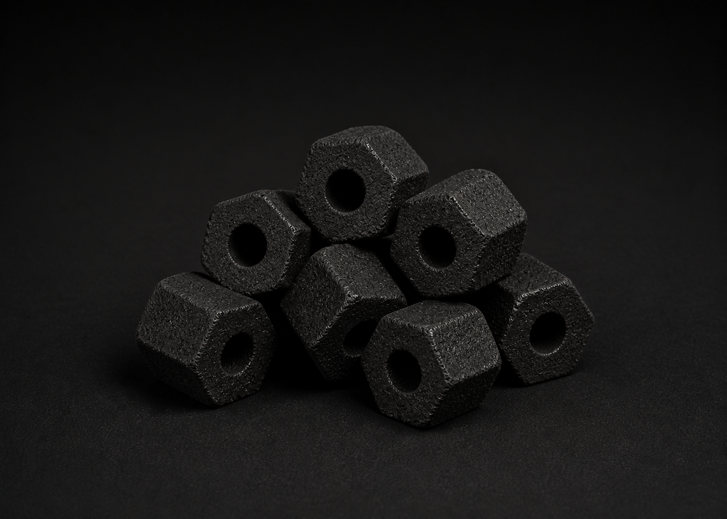 Illustrative group of unlit hexagonal BBQ sawdust briquettes