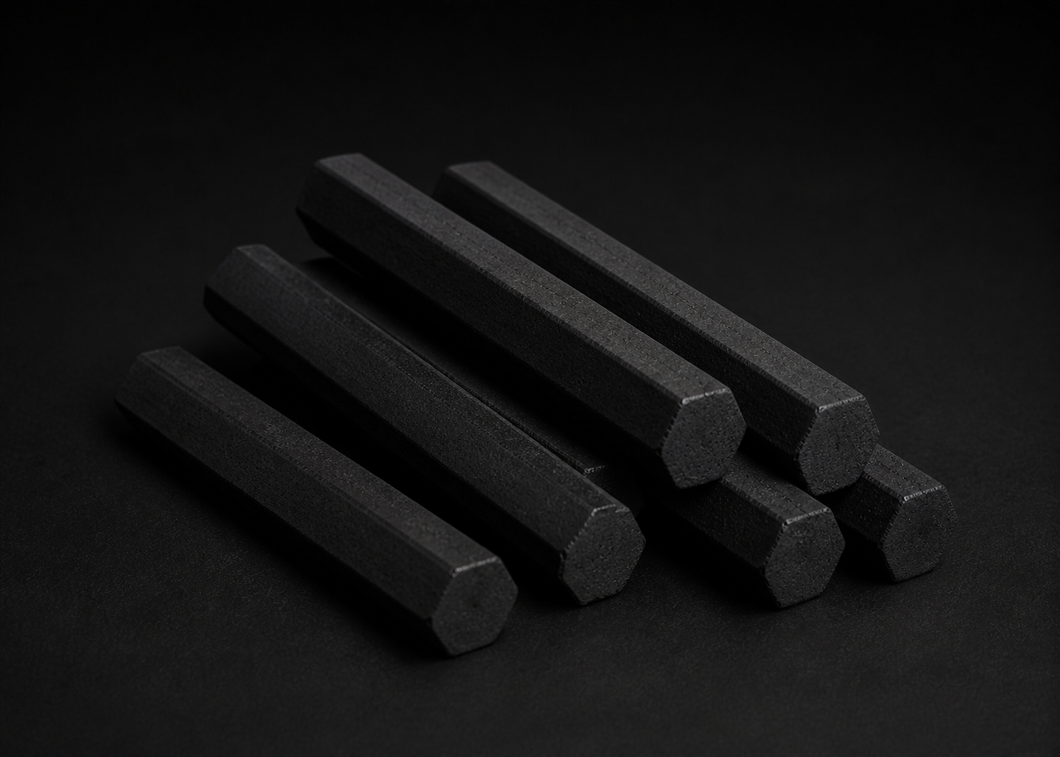 Illustrative slender six-sided hexagonal charcoal rods listed as 150 by 18 millimetres